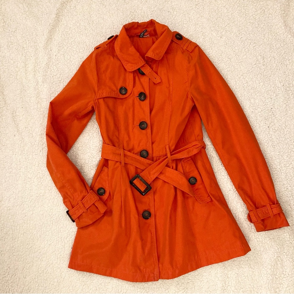Bold red-orange trench coat